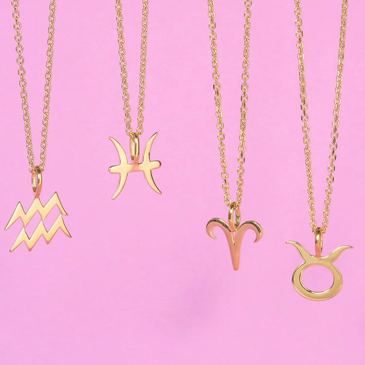 14k gold plated necklaces over sterling silver in 4 zodiac symbols displayed against a soft pink background