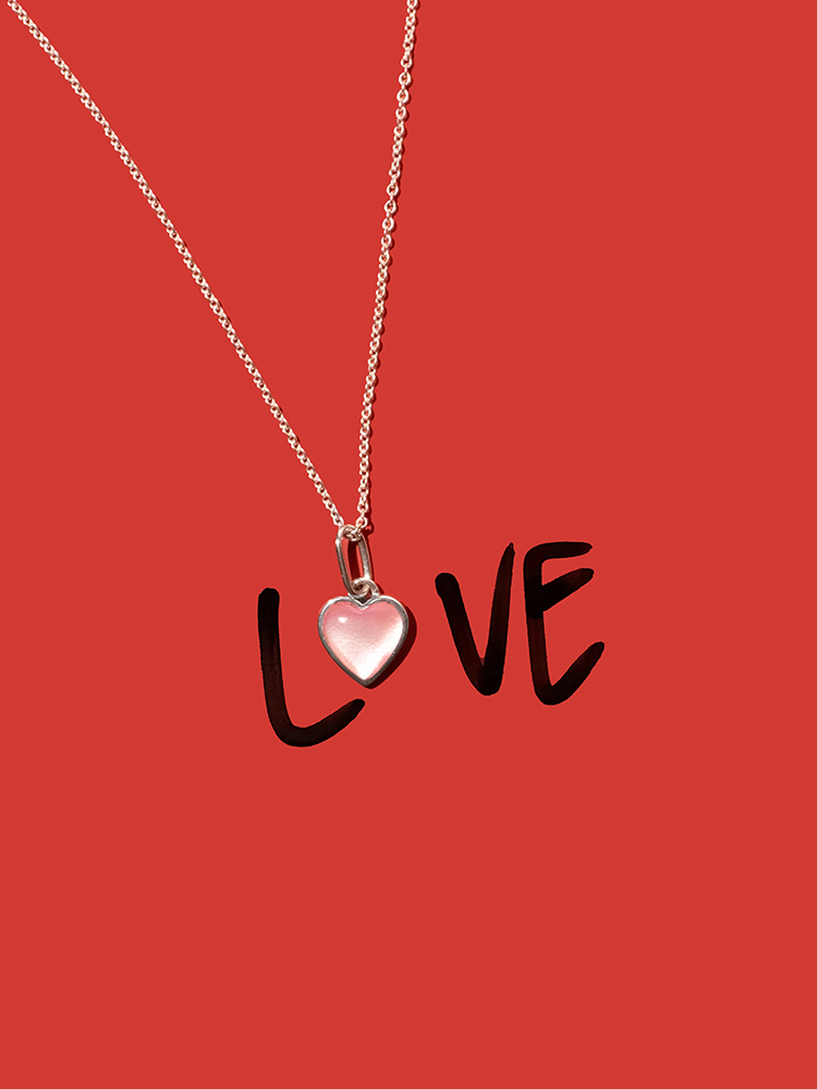 a sterling silver heart pendant necklace with pink mother of pearl stone with the words love and red background